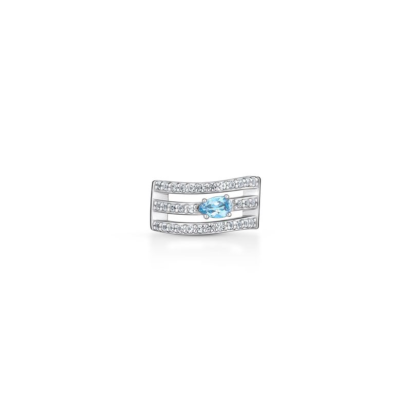 Anillo prateado com várias pedrinhas brancas e uma pedra azul no centro, em fundo branco.